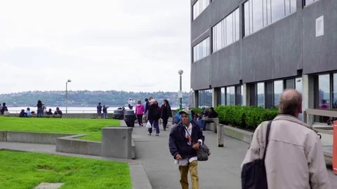 Crowd of people look out over Elliot's bay in Seattle Stock Footage 73503288