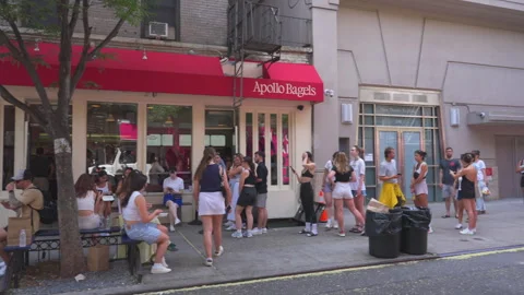 Crowd of people make long line to buy Bagels at Apollo Bagels in East Village Video stock 280945109