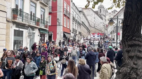 Crowd Of People Marching Through Lisbon City Street Video stock 325977068