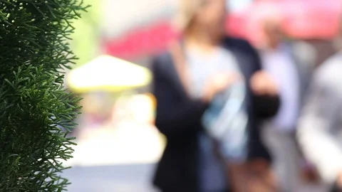 Crowd of people in multi colored clothes walking on a sunny day in the city. Video stock 78001182