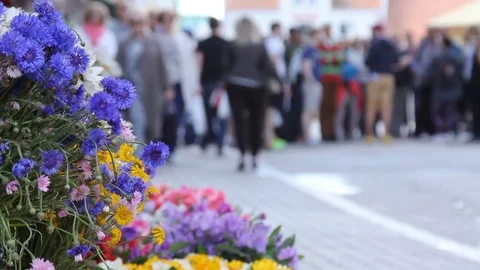 Crowd of people in multi colored clothes walking on a sunny day in the city.  3 Stock Footage 78001343