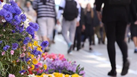 Crowd of people in multi colored clothes walking. Sunny day in the city. Video stock 78001352
