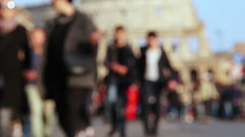 Crowd of people out of focus walking in front the coloseum in Rome Stock Footage 55799259