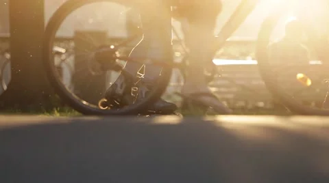 Crowd of people in the park walking through sun flare. Bicycles, roller skates Stock-Footage 61692187