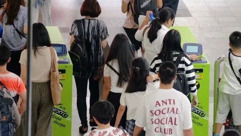 Crowd of people passing through ticket gate at BTS Siam Station Stock Footage 115960012