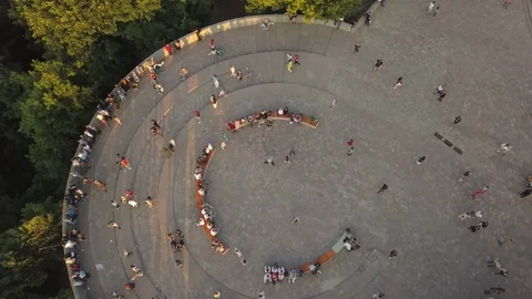 A crowd of people on a pedestrian bridge in the spring evening. Aerial view Stock Footage 108688512