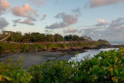 Crowd of people in a procession in front of a beach Stock Photos