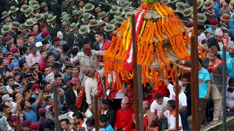 A crowd of people pull the decorated chariot of Kumari the Living Goddess Stock Footage 139414449