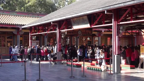 Crowd of people queuing at a traditional red pavilion in Taipei Stock Footage 345998008