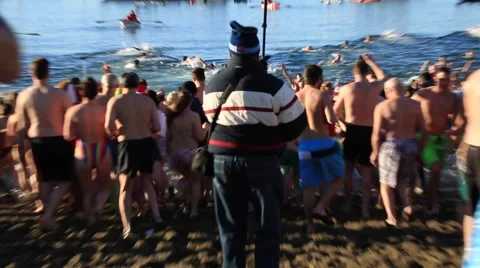 Crowd of people running with screams into cold water, Vancouver Stock Footage 58756280