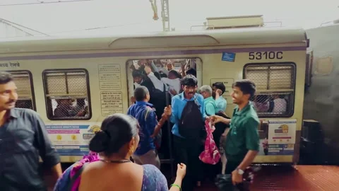 Crowd of People Rush to Board Local Train at Dadar station Mumbai city. Stock Footage 247169557