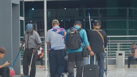 Crowd of people at smoking zone in Kuala Lumpur International Airport. Stock Footage 101068923
