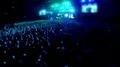 Crowd of people standing and jumping in front of big stage at stadium, concert HD Footage