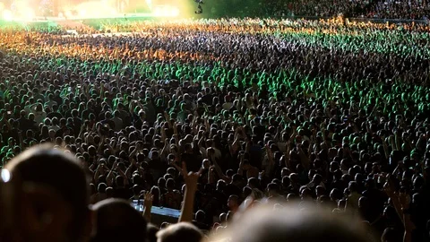 Crowd of people standing in fan zone during rock or pop music concert. 4K Stock Footage