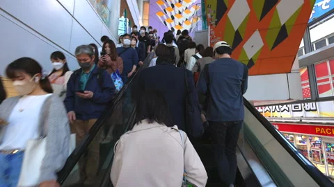A crowd of people takes the elevator at the Shibuya Mark City Tokyo Japan Stock Footage 210239589