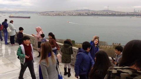 A crowd of people, tourists, on the observation deck. They admire the view of Stock Footage 88104729