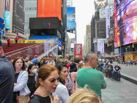 A crowd of people waiting on line to get theater tickets Stock Photos