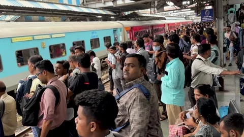 Crowd of people waiting for a local train to arrive at a railway station Stock Footage 341455716