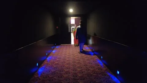 Crowd of People walk into movie theatre to watch Indian film on big screen. Stock Footage 198130723