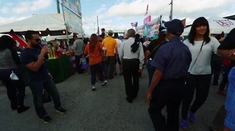 Crowd of people walking around during festival. Puerto Rican flags Stock Footage 47824213