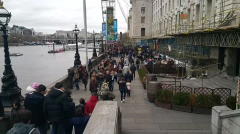 Crowd Of People Walking beside Thames River, Central London Stock Footage 58024678