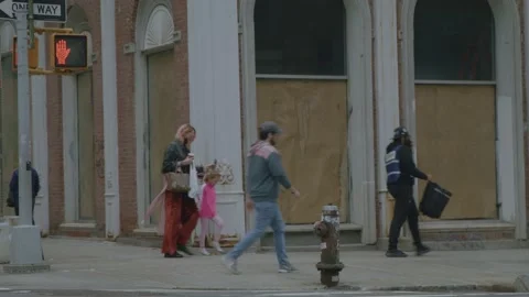 Crowd of People walking by closed storefront Downtown SoHo NYC Stock Footage 162355522