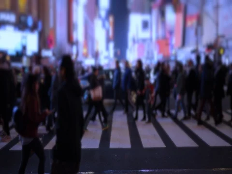 Crowd of people walking crossing street in New York City slow motion at night Stock Footage