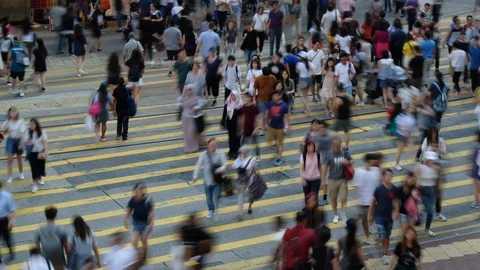 Crowd of people walking crossing street at a busy intersection in Hong Kong, Stock Footage