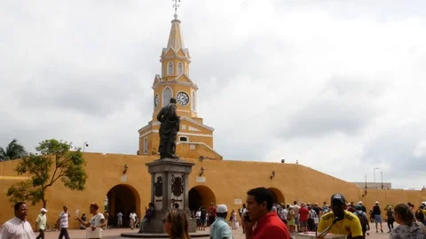 Crowd of people walking in front of the clock tower gate in Cartagena old town. Vidéo 121530973