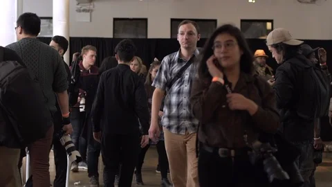 Crowd of people walking indoors in 120fps slow motion Stock Footage
