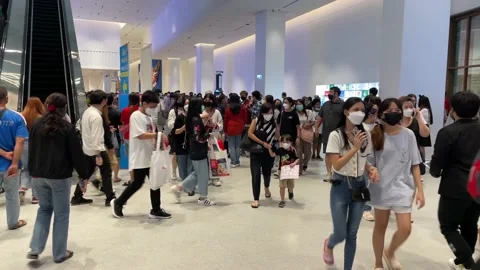 Crowd of people walking inside Queen Sirikit National Convention Centre Stock Footage 219741738