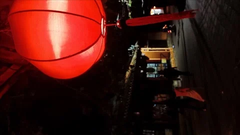 Crowd of people walking past a temple at night in Hoi An old town Stock Footage 248554347
