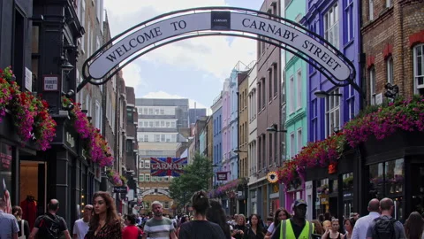 Crowd Of People Walking in Slow Motion On Carnaby Street under sign, Soho London Stock Footage 149270657