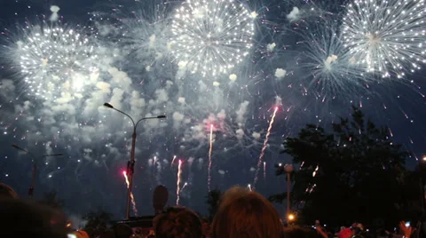 Crowd of people watching fireworks in night city Stock Footage