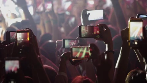 A crowd of people waving their phones at the concert. Stock Footage