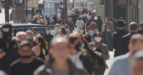 Crowd of people wearing mask masks walking street city coronavirus covid-19 Stock Footage