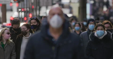 Crowd of people wearing mask masks walking street city coronavirus covid-19 Stock Footage