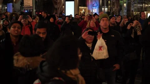 Crowd of people at a winter night looking at something [SloMo] Stock Footage 164112163