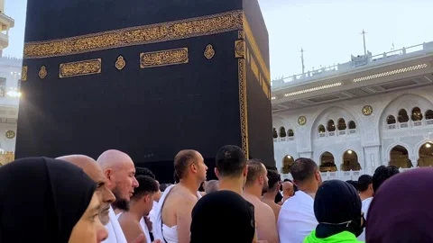 A crowd of pilgrims performing Tawaf around the Kaaba in the Grand Mosque of Stock Footage 346926548