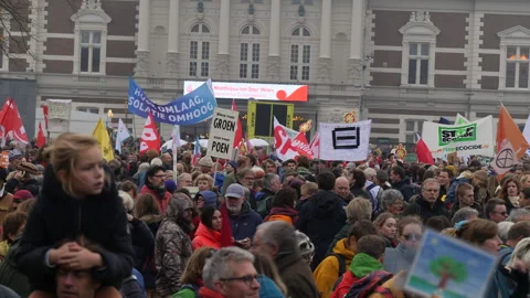 Crowd with protest signs in Dutch at Climate March. Amsterdam, Netherlands 2023t Stock Footage 258043149