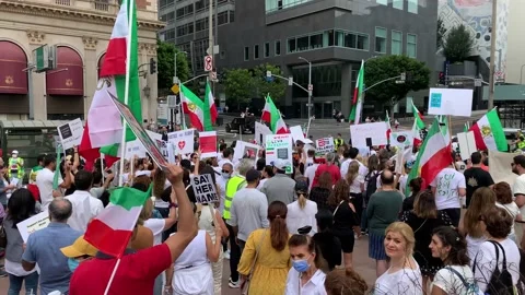 A Crowd of Protesters Gather with Flags and Signs to Call for Freedom in Iran Stock Footage 216173171