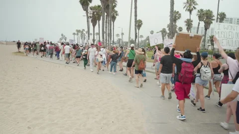A Crowd of Protesters March Next To The Santa Monica Beach Stock Footage 199188041