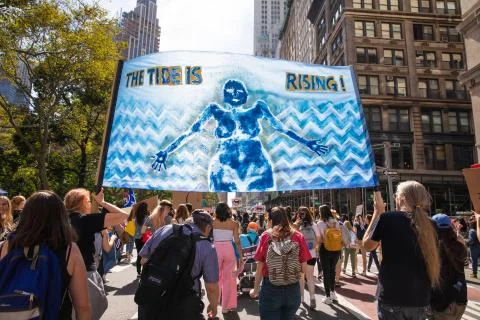 A Crowd of Protesters Marching with a Banner During Climate Strike NYC 2019 Stock Photos