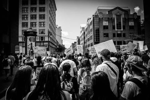 Crowd protesting with placards in city Stock Photos