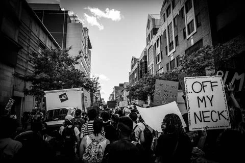 Crowd protesting with placards on road Stock Photos