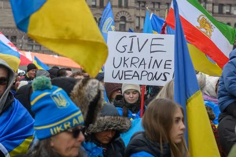 Crowd protesting Russian invasion of Ukraine demanding weapons Stock Photos