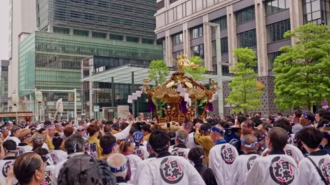 Crowd Raises Hands Around Golden Shrine Amid City Greenery Stock Footage 341375196
