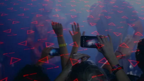 Crowd raising smartphones while capturing live music show, with red triangular 動画素材 308047093