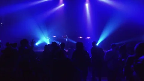 Crowd at rave party, people dance in blue light of projectors Stock Footage 70138408
