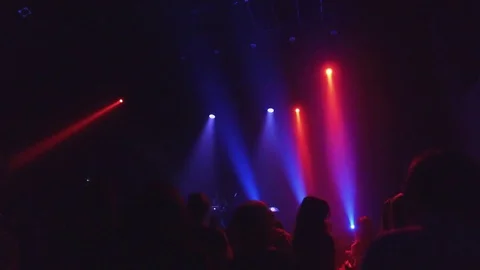 Crowd at rave party, people dance in blue light of projectors Stock Footage 70138540